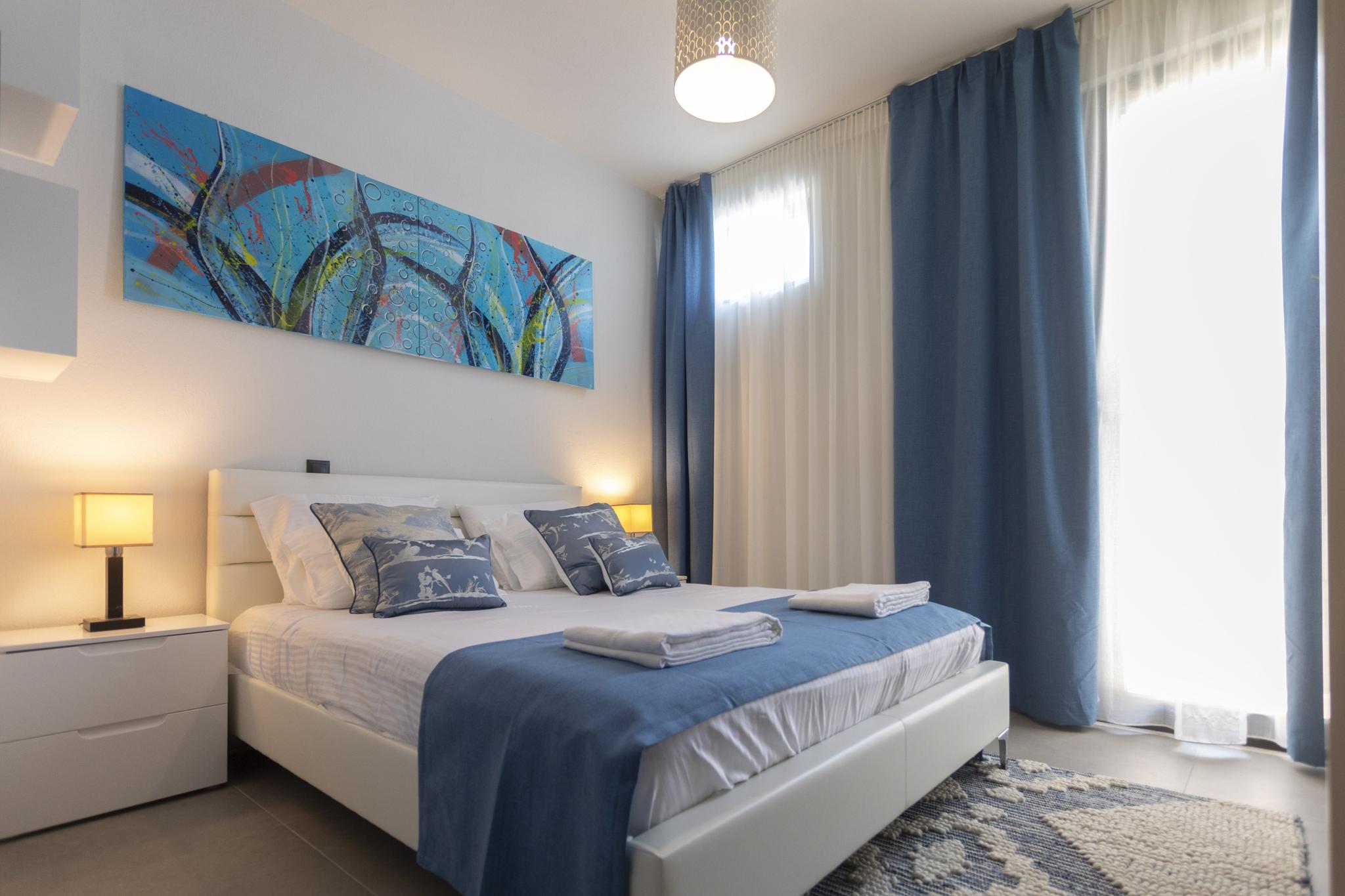 Sunlit bedroom at Damari villa in Skiathos, a short drive from Koukounaries golden sand beach