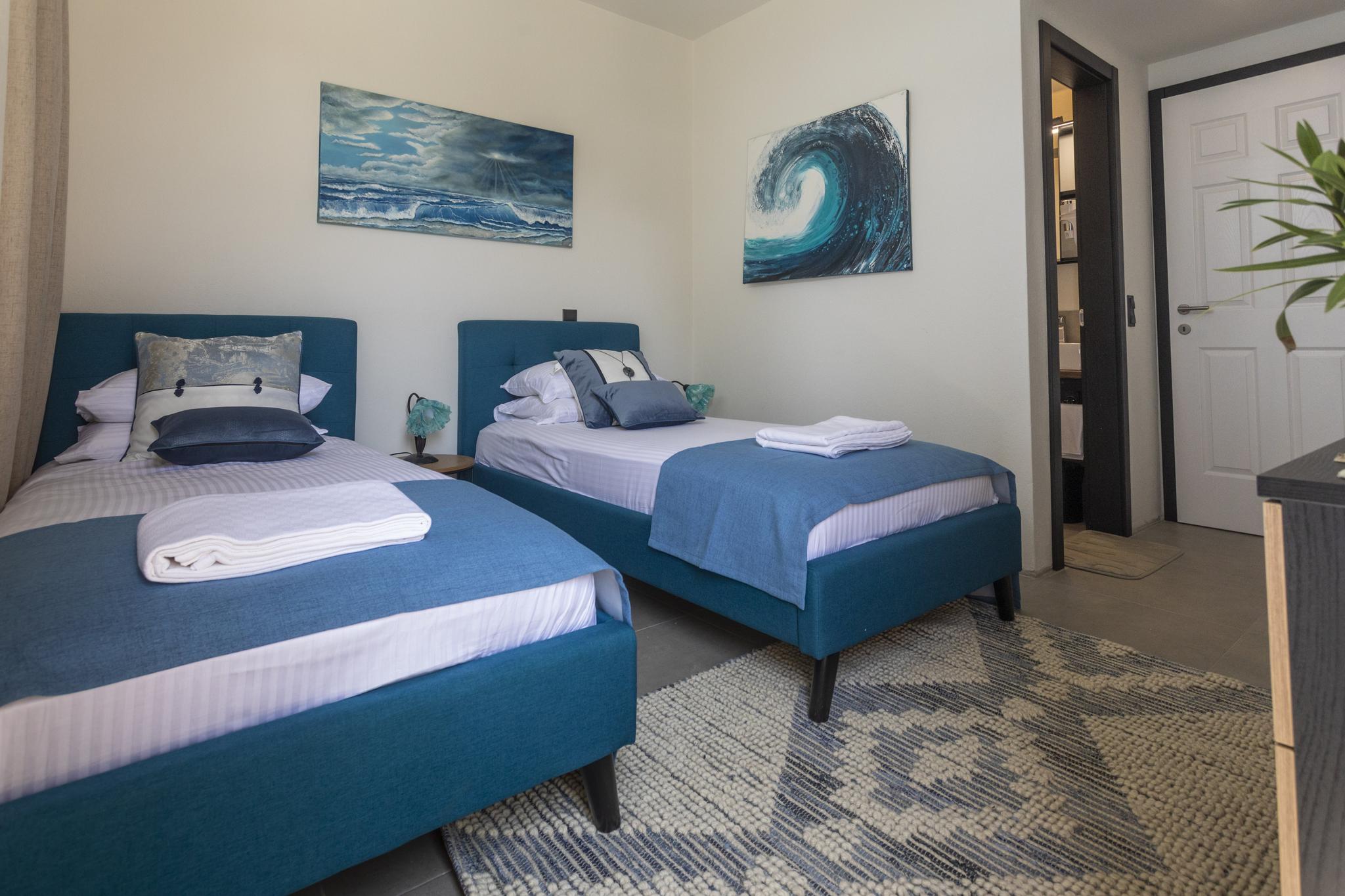 Lalaria Beach Skiathos with smooth white marble pebbles, turquoise water and the Tripia Petra natural rock arch