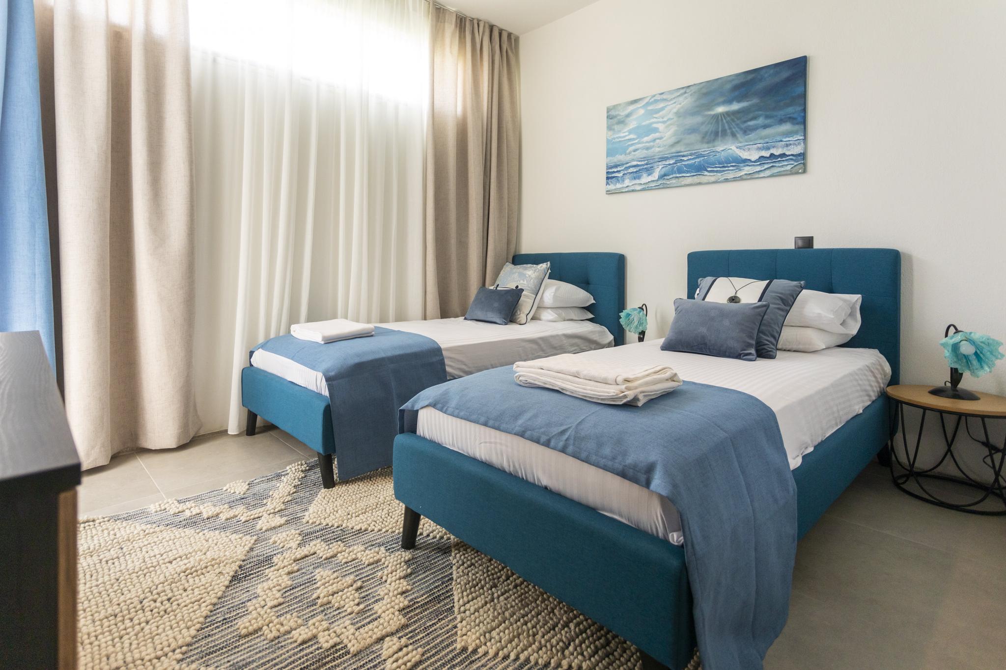 Sunlit bedroom at a luxury villa in Skiathos, Greece, base for exploring the Sporades islands on a Greek island hopping trip